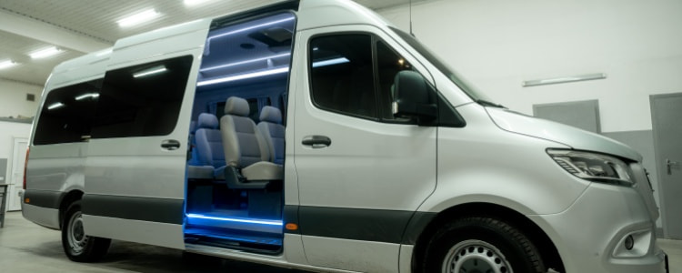 White minivan charter bus rental with door open
